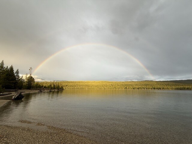 Rainbow arcing over a lake after a storm